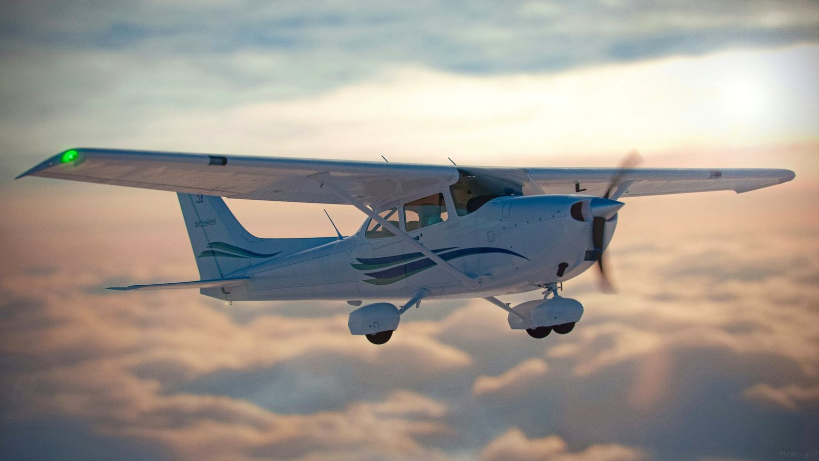 Single-engine general aviation aircraft in flight above clouds at sunset